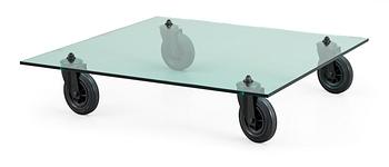 24. A Gae Aulenti glass and rubber wheel sofa table, 'Tavolo con Ruote', Fontana Arte, Italy.