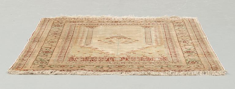 A RUG, an antique silk Tabriz, ca 165 x 118,5-111,5 cm.