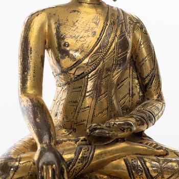 A gilt copper-alloy figure of Aksobhya Buddha, 14th/15th century, Tibet or Nepal.