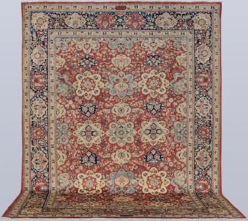 A Sarouk carpet, signed, approx. 327 x 253 cm.