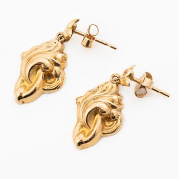 A pair of 18K gold earrings.