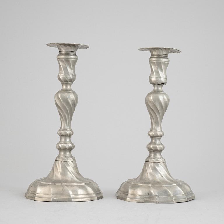 A pair of rococo style pewter candlesticks, 19th Century.