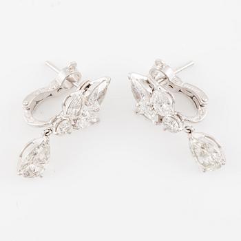 Cartier a pair of earrings platinum set with drop-shaped and round brilliant-cut diamonds.