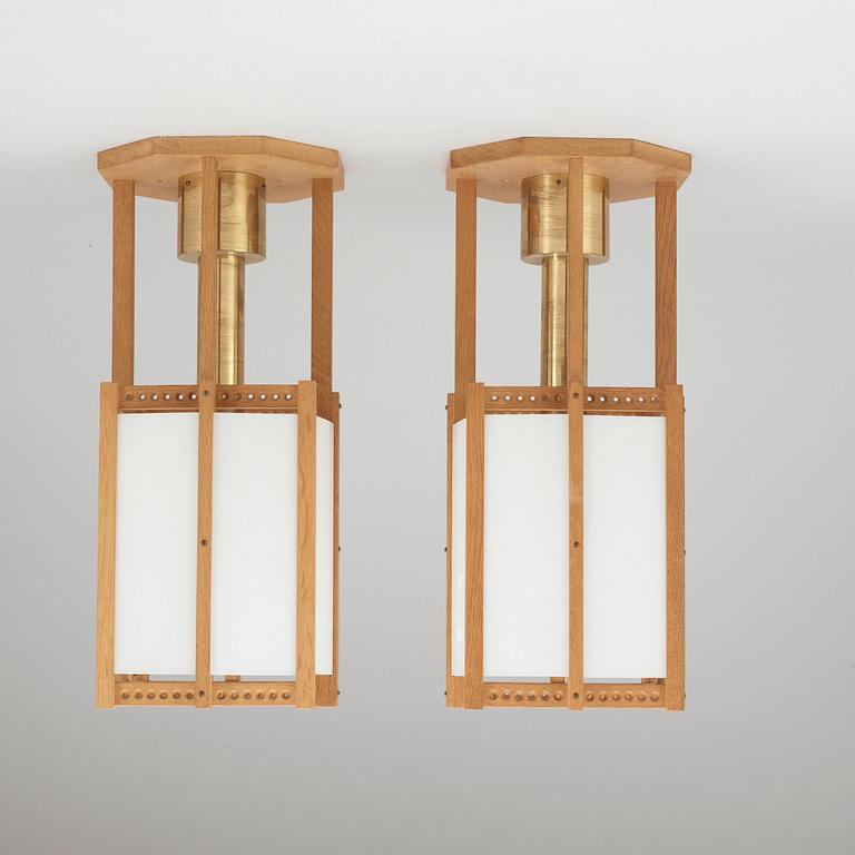 A pair of John Kandell oak, brass and opaque glass celing lamps, Sweden 1950's.