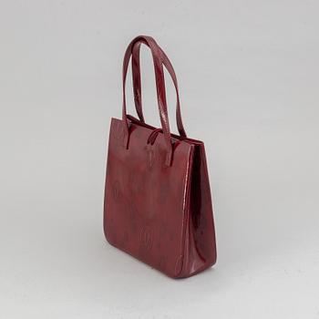Cartier, a burgundy patent leather handbag and wallet.