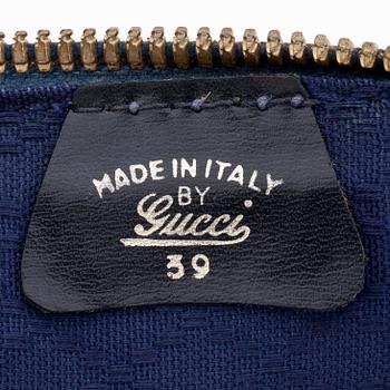 GUCCI, a blue suede and leather weekendbag.