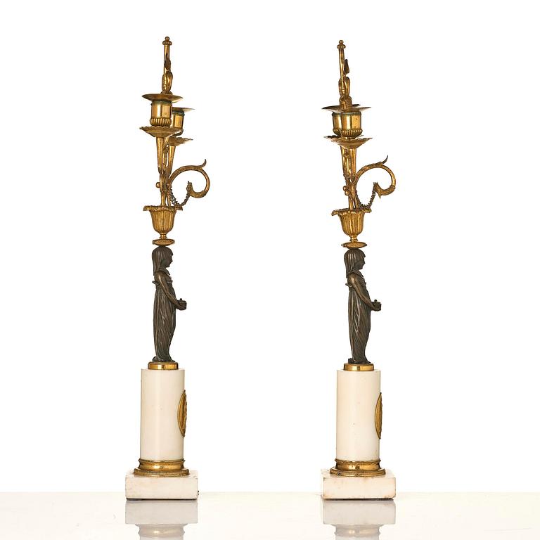 A pair of late Gustavian white marble and bronze candelabra.