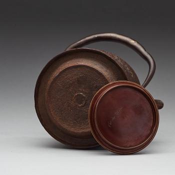 A Japanese iron and bronze tea pot with cover, Meiji period 1868-1912).