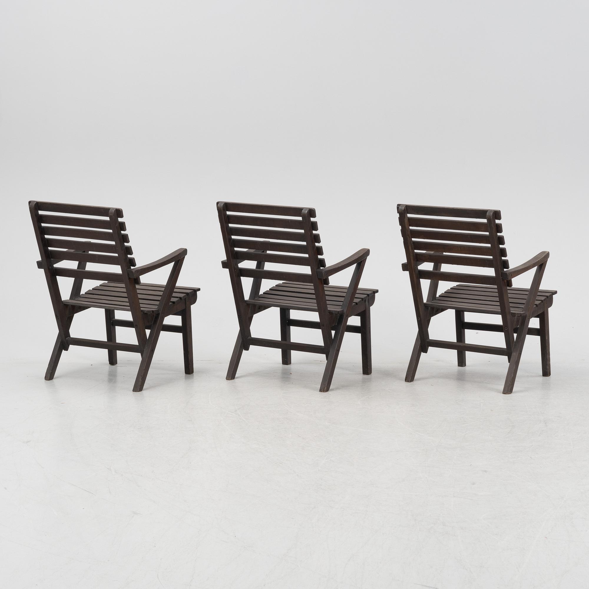 Carl Malmsten, a set three stained pine armchairs, Igelstaverken, second half of the 20th Century.