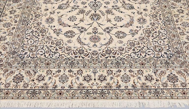 A Nain, part silk carpet, 305 x 207 cm.