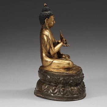 A gilt and silvered copper alloy repoussé figure of Sakyamuni Buddha, Tibet/Nepal, 18th Century.