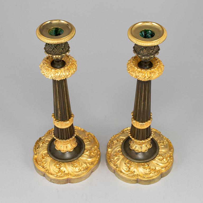 A pair of ormolu late empire candlesticks, mid 19th century.