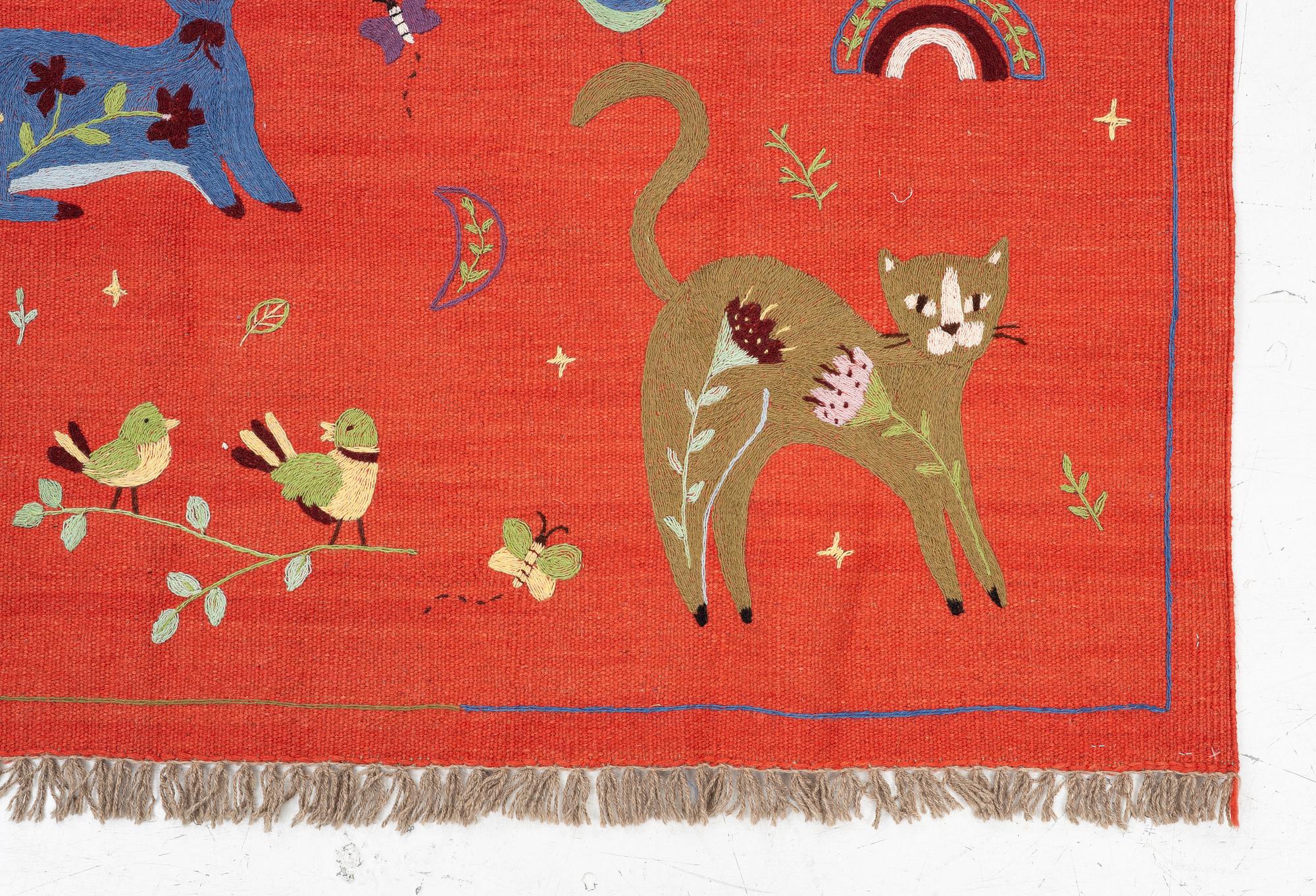 A hand-embroidered Kilim rug, c. 182 x 122 cm.