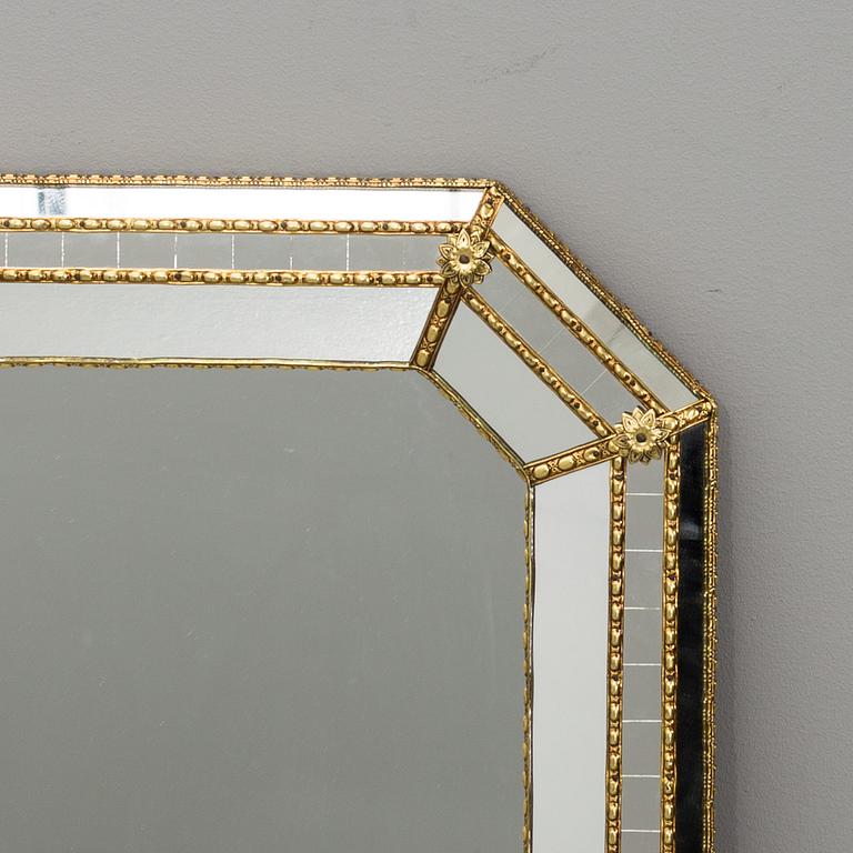 A WALL MIRROR MADE IN SPAIN.