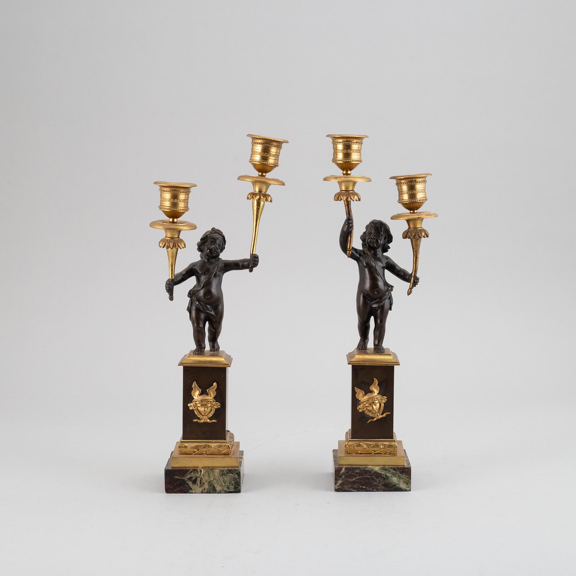 A pair of bronze empire style candleabra, 20th century.