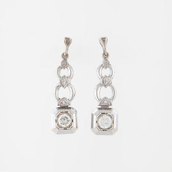 A pair of brilliant cut diamod earrings.