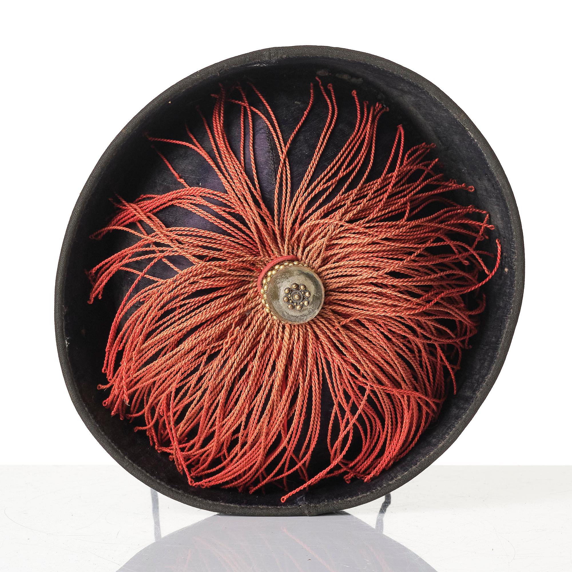 Two boxes with a mandarin's summer hat and black satin autumn hat and feather with six mandarin hat insignias.