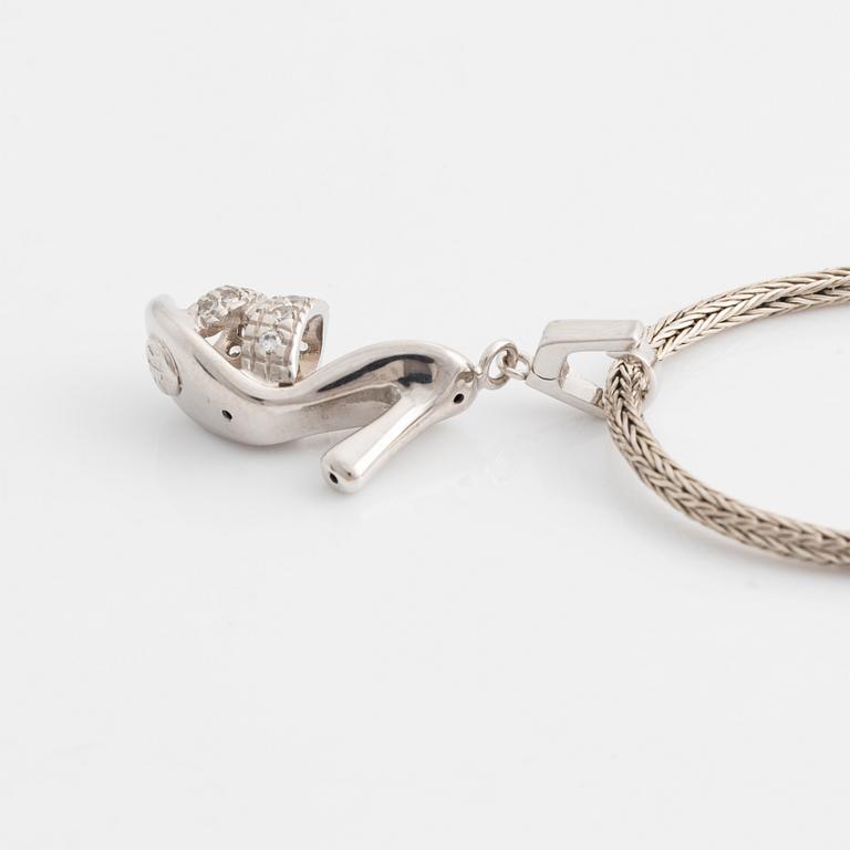 18K white gold shoe pendant with faceted white stones, silver chain.