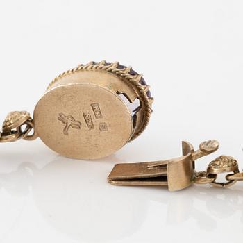 A set with a necklace, a bracelet, a brooch, and a ring.