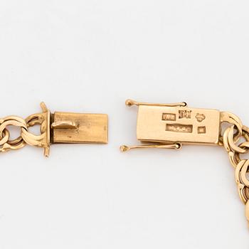 An 18K gold charm bracelet.