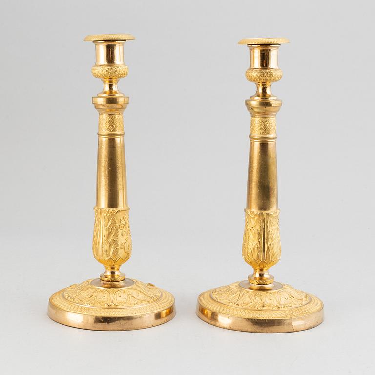 A pair of french gilt bronze candle holders, around 1820.