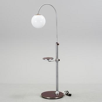 a metal floor light with table from the 1930s.