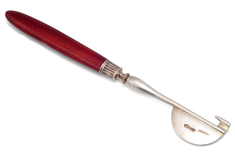 A FABERGÉ SILVER AND GUILLOCHÉ ENAMEL ORANGE PEELER.