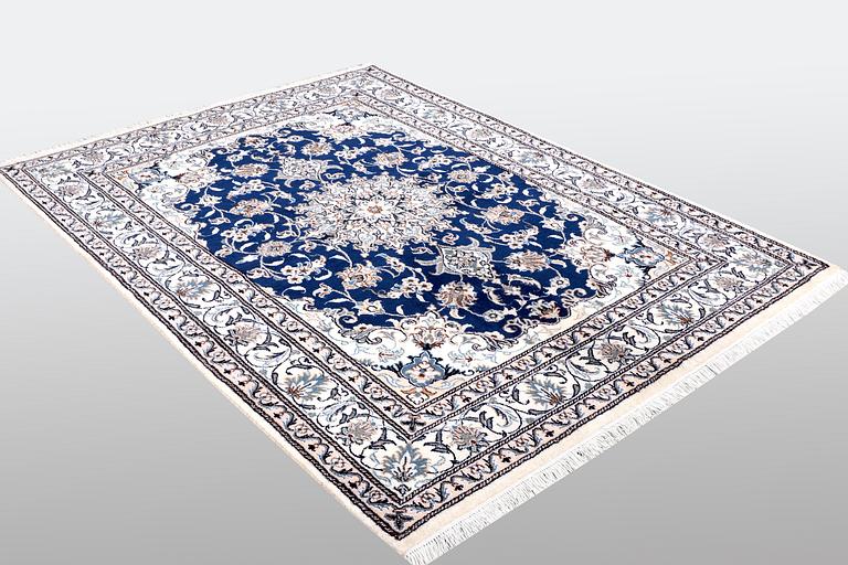 A Nain rug, part silk, ca 205 x 152 cm.