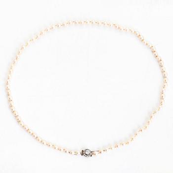 A cultured pearl necklace, clasp with white zircons.