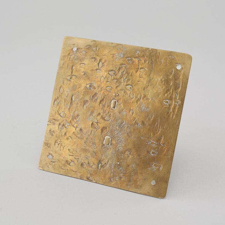 A brass sundial dated 1715.
