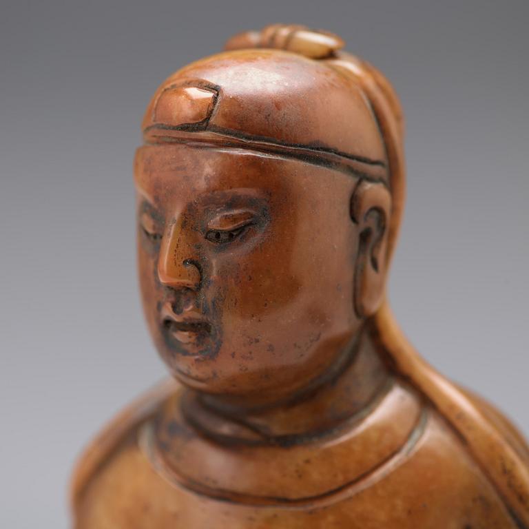 A soapstone sculpture of a mandarin official, late Qing dynasty.