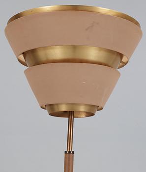 A beige lacquered floor lamp, with brass and artificial leather, possibly a scetch by Alvar Aalto, 1950's.