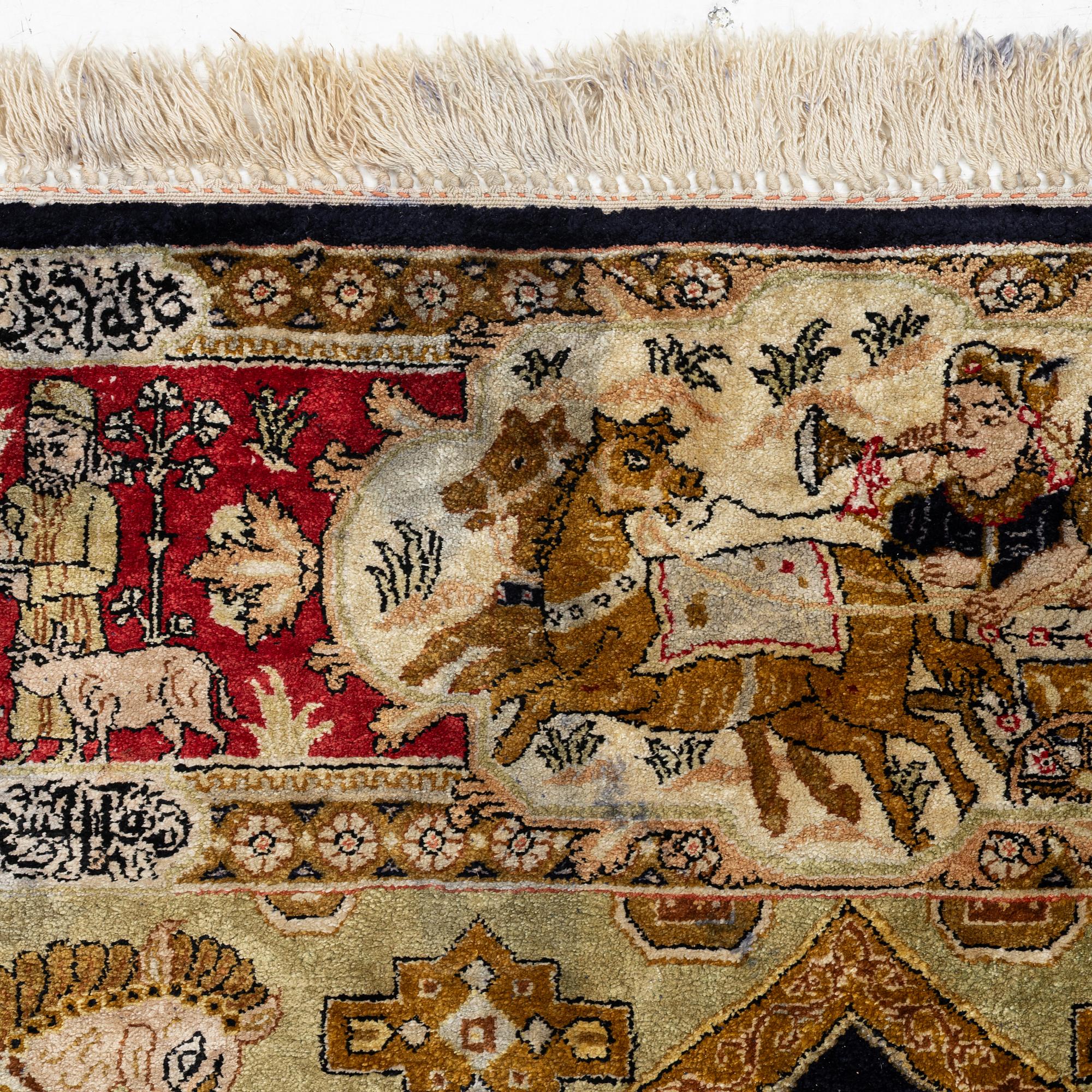 A pictorial semi-antique silk Qum rug, central Persia, c. 214 x 146 cm.