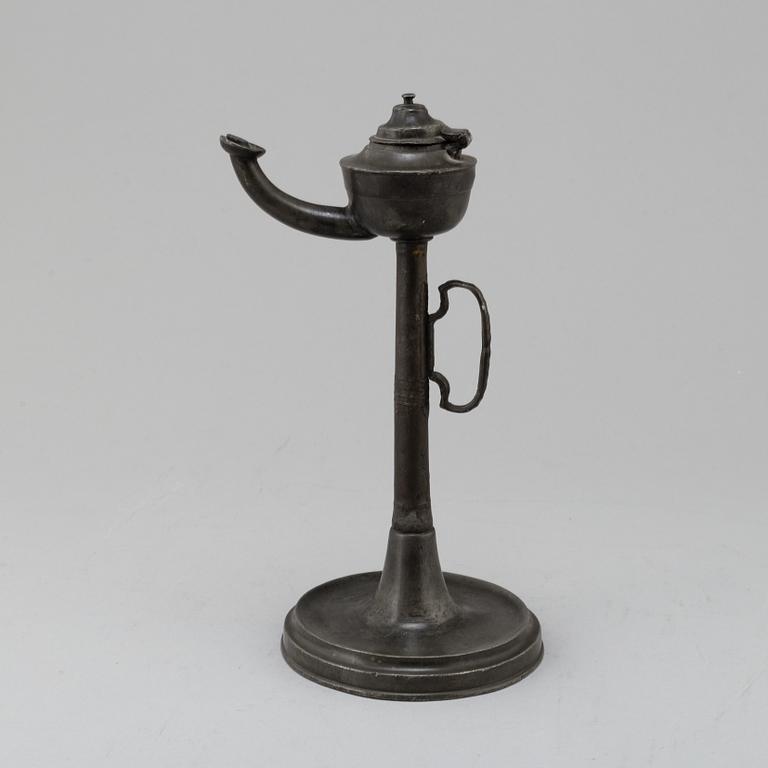 An 18th century pewter oil lamp.