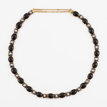A necklace/bracelet combination 18K gold and silver set with onyx and rose-cut diamonds, 19th century.