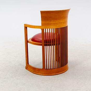 A cherry wood model 606 'Barrel' chair by Frank Lloyd Wright from Cassina.