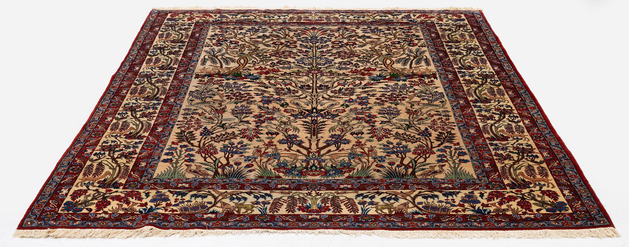 A semi-antique Qum carpet, Central Persia, c. 312 x 215 cm.