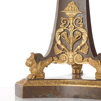 A pair of French Empire early 19th century gilt and patinated bronze four-light candelabra.