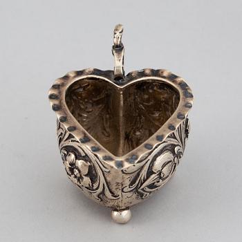 A small silver Baroque style  heart-shaped jug on ball feet.