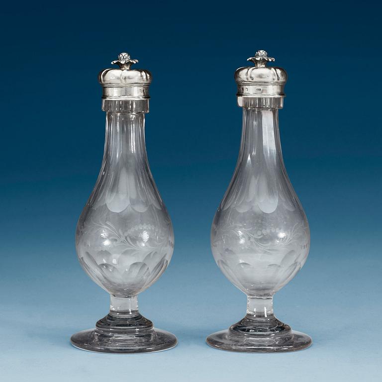 A pair of Swedish 18th century glas-bottles and silver-covers, marks of Arvid Floberg, Stockholm 1766.
