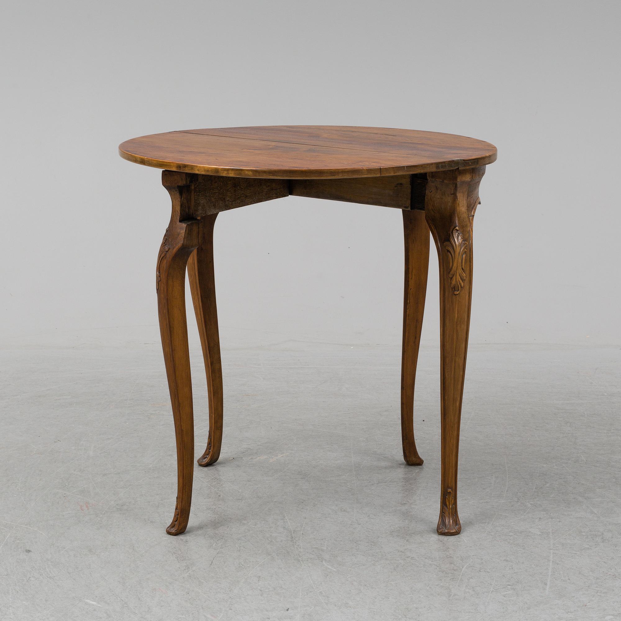 A rococo style card table from around year 1900.