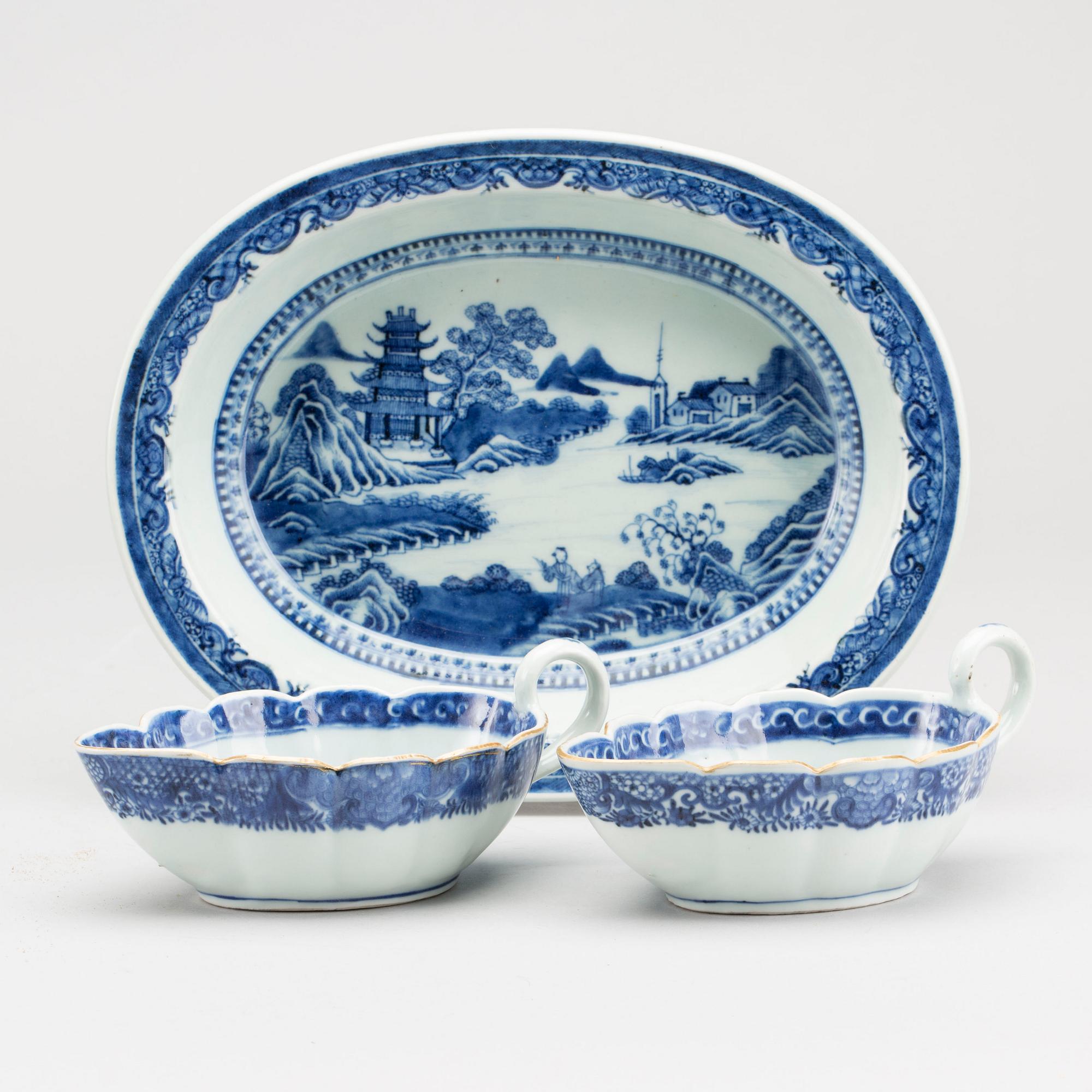A blue and white Chinese Qianlong porcealin pair of sauce boats and a serving dish.
