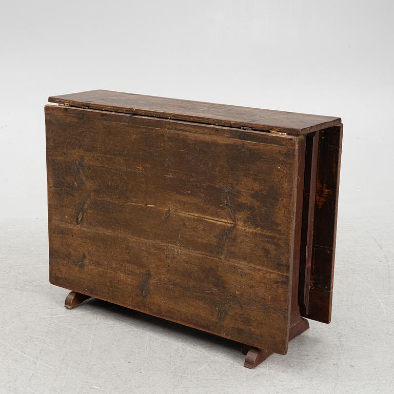 A drop-leaf table, 19th Century.