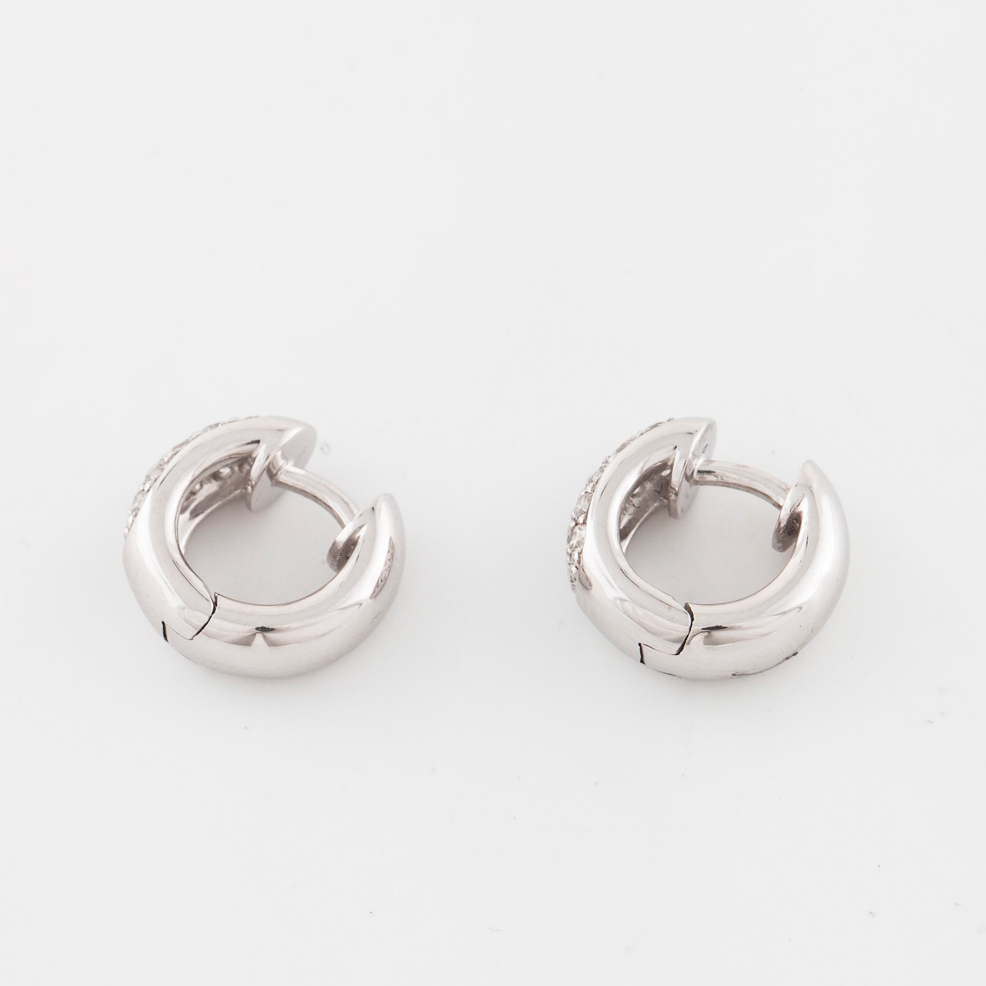 A pair of brilliant cut diamond earrings..