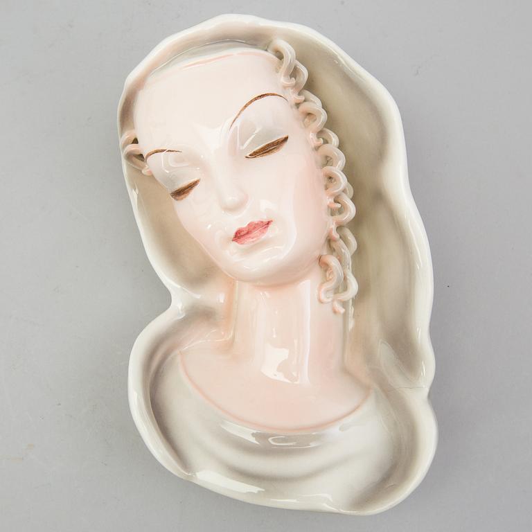 A late 1930s porcelain Goldscheider wall mask, model 7894, marked "Goldscheider Wien" and Made in Germany.