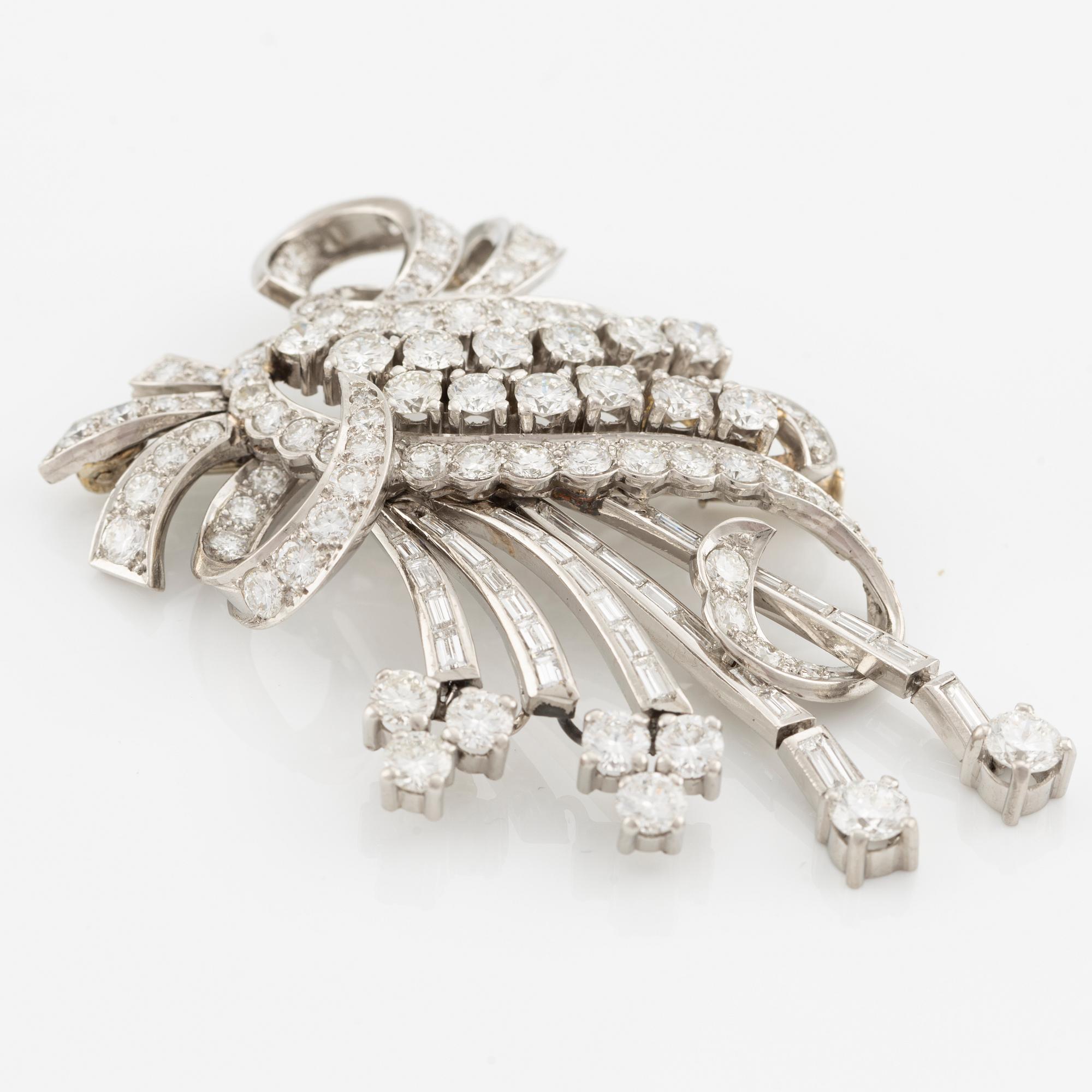 A platinum brooch with round brilliant and baguette-cut diamonds.