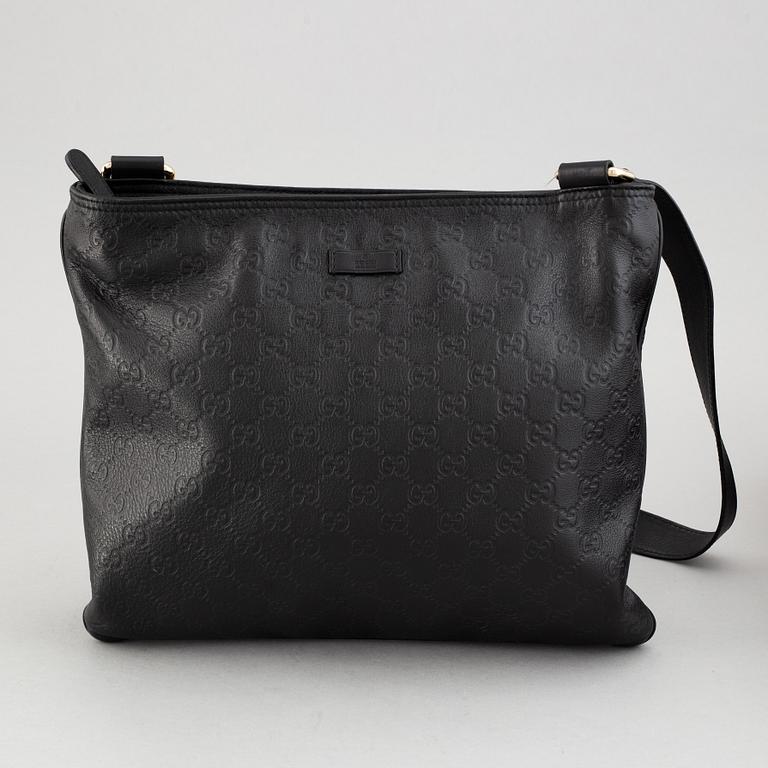 Gucci, a leather messenger bag.