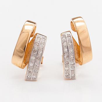 A pair of 14K gold earrings with diamonds ca 0.14 ct in total.