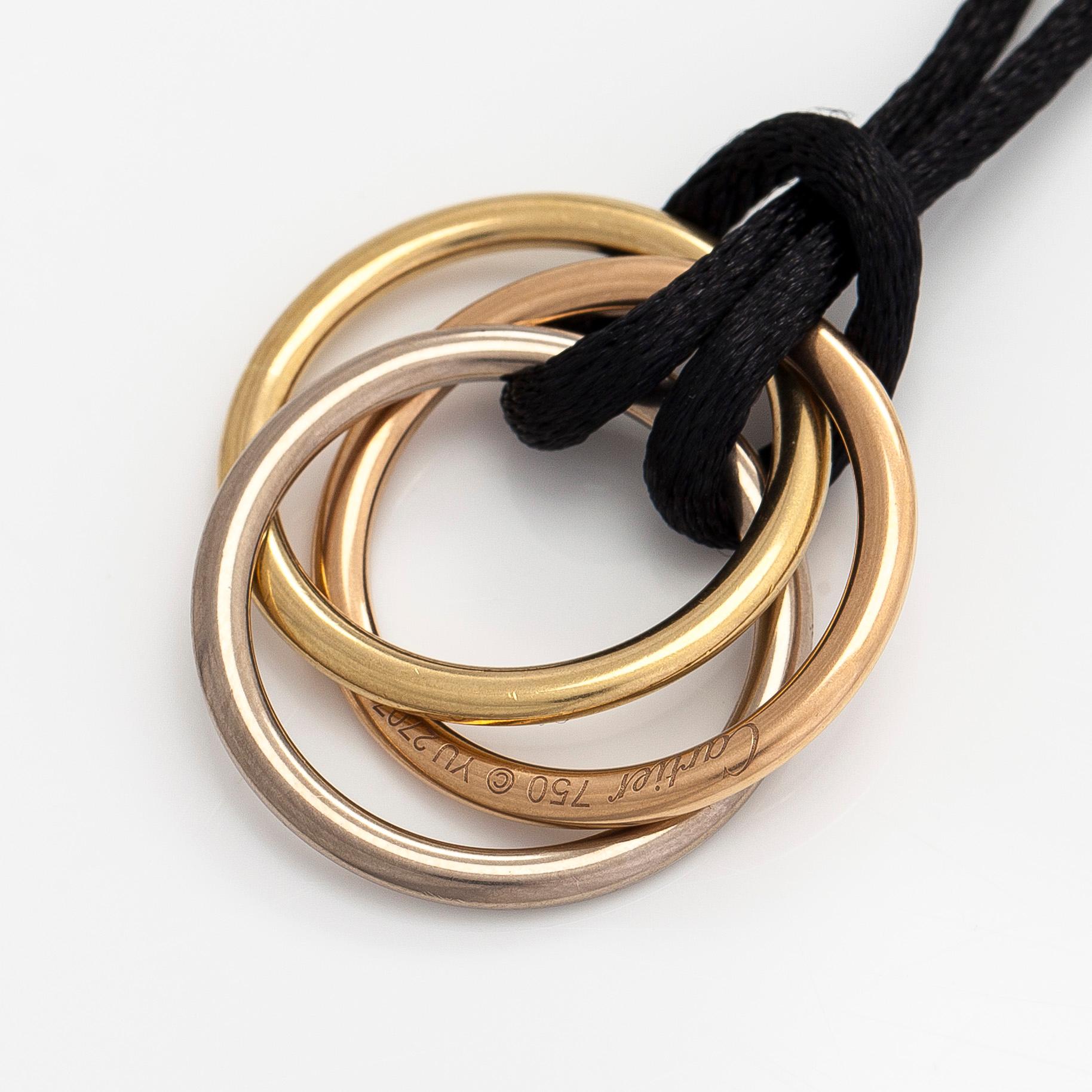Cartier, necklace/pendant, "Trinity", 18K tricolour gold with black silk cord.