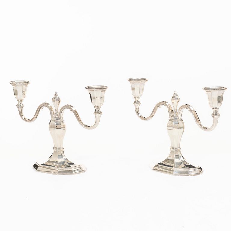 A pair of silver candelabras, with Swedish import marks, possibly mid20th century.